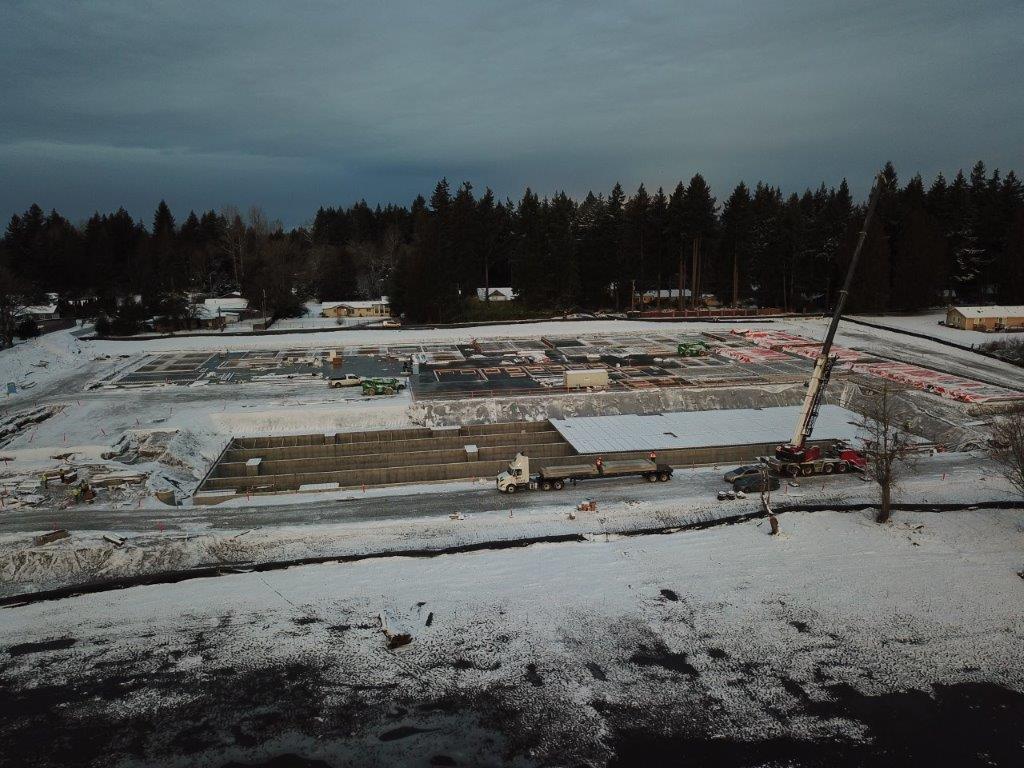Concrete detention vault construction with panel installation
